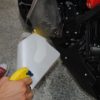 Positioning film in place for installation on Aprilia Shiver