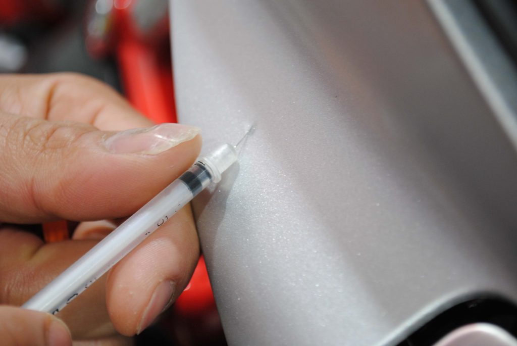 Using a syringe to remove air bubbles