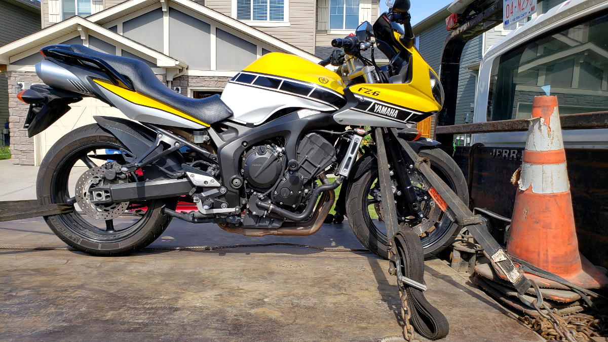 Cam's FZ6 secured via four-points on a flatbed tow truck