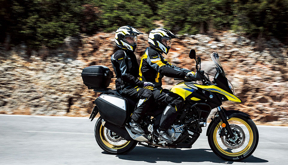 A rider and pillion on a fully-kitted Suzuki V-Strom 650XT
