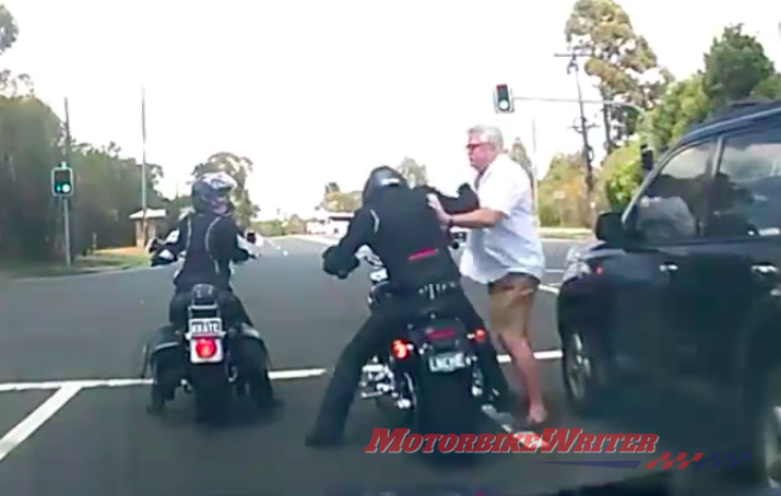 Man pushing motorcyclist at stop during road rage incident