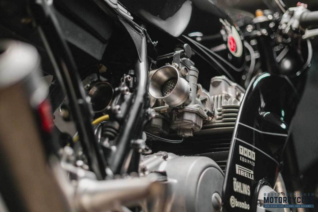 a close-up shot of free-flowing carbs on a motorcycle