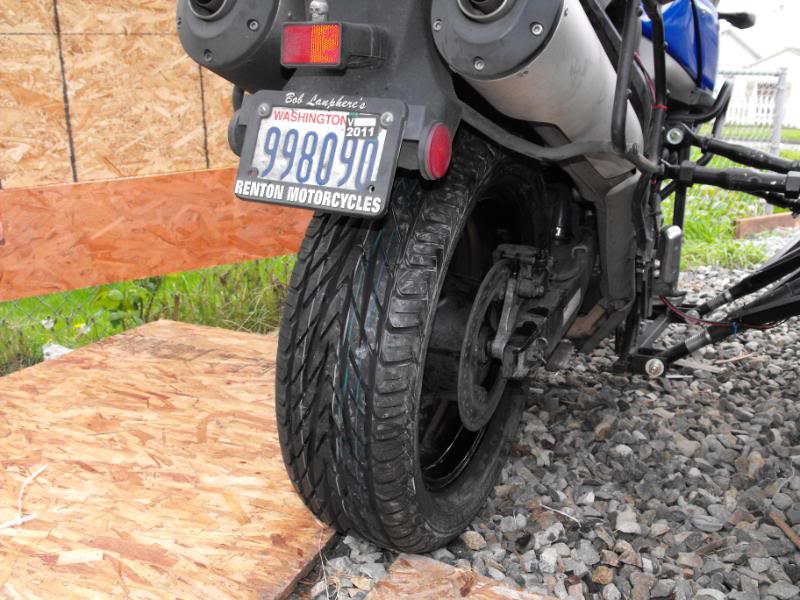 A motorcycle with car tyre mounted on the rear wheel