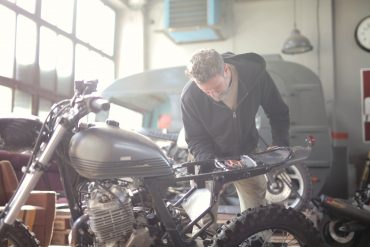 Man working on a motorcycle in a mechanic shop