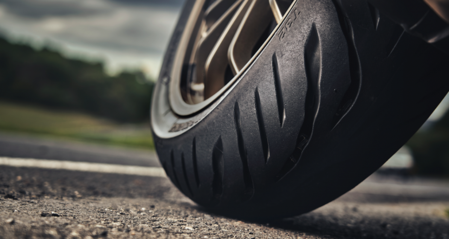 Close up of motorcycle tire leaning on road