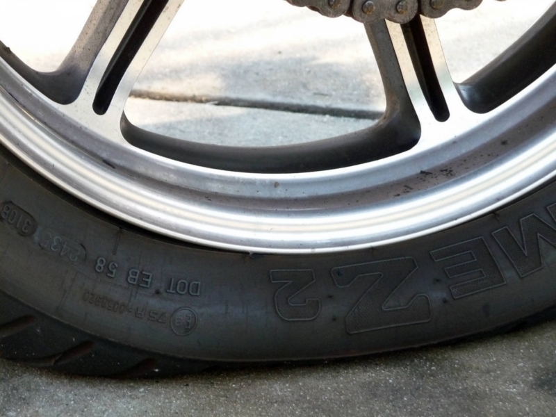  A motorcycle tyre that is partially deflated thanks to being left over winter