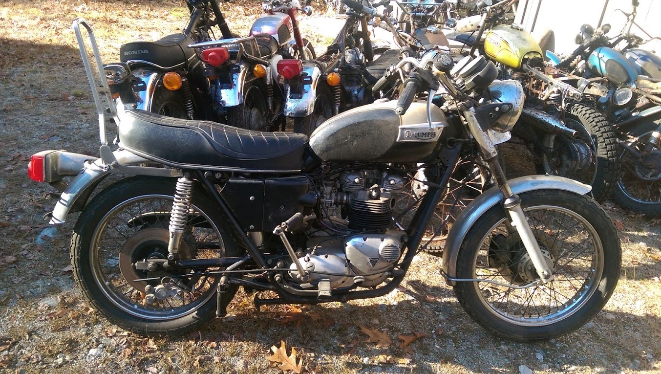 an old Triumph motorcycle at a motorcycle wreckers