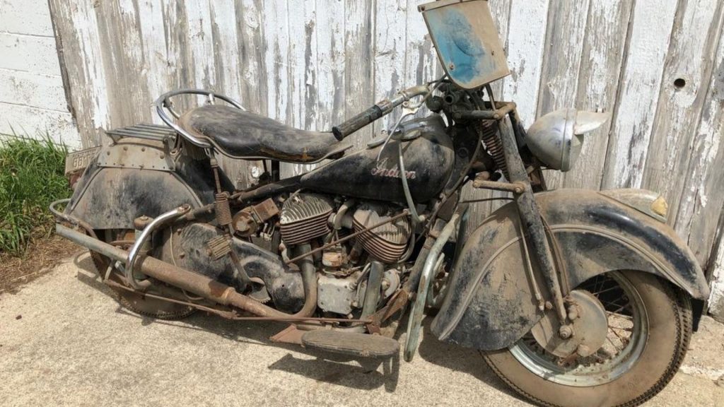 a barn find indian motorcycle covered in dust