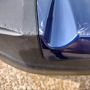 Scratched paint on blue motorcycle fairing