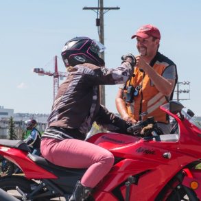 Female rider on a red Kawasaki Ninja
