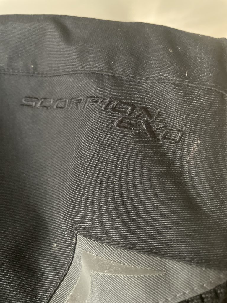 Close up of Scorpion EXO logo on textile motorcycle jacket