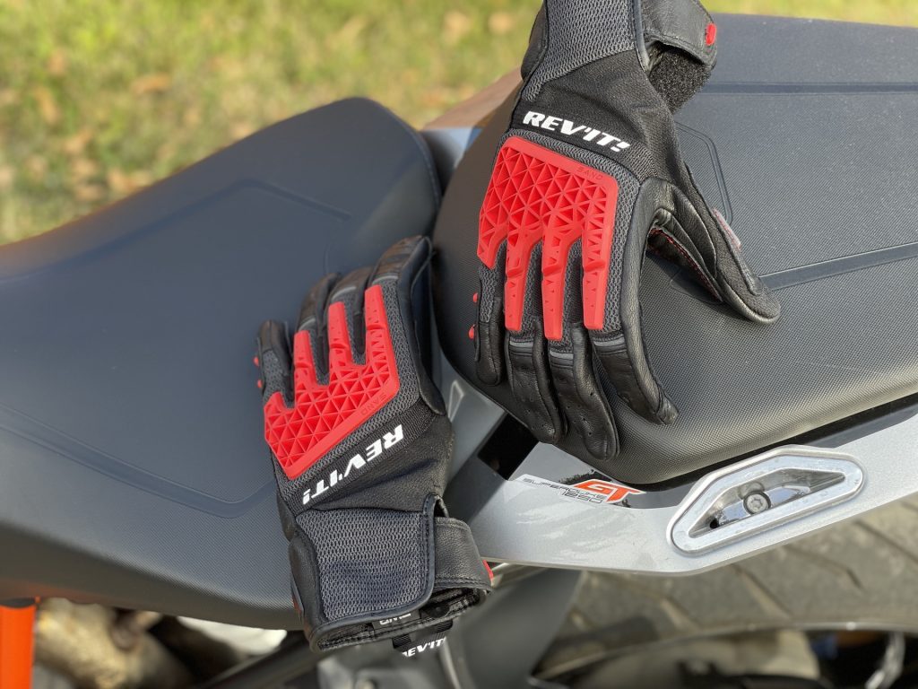REV'IT motorcycle gloves on tank of bike