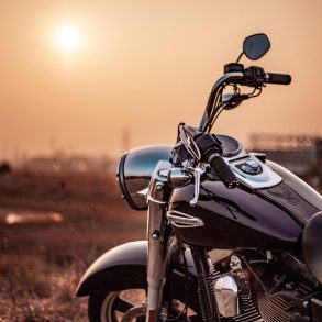 Black cruiser motorcycle outside near sunset