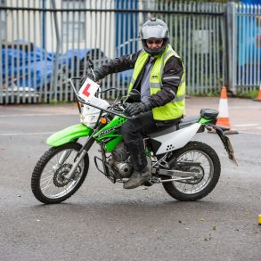 Rider on motorcycle executing u-turn in parking lot