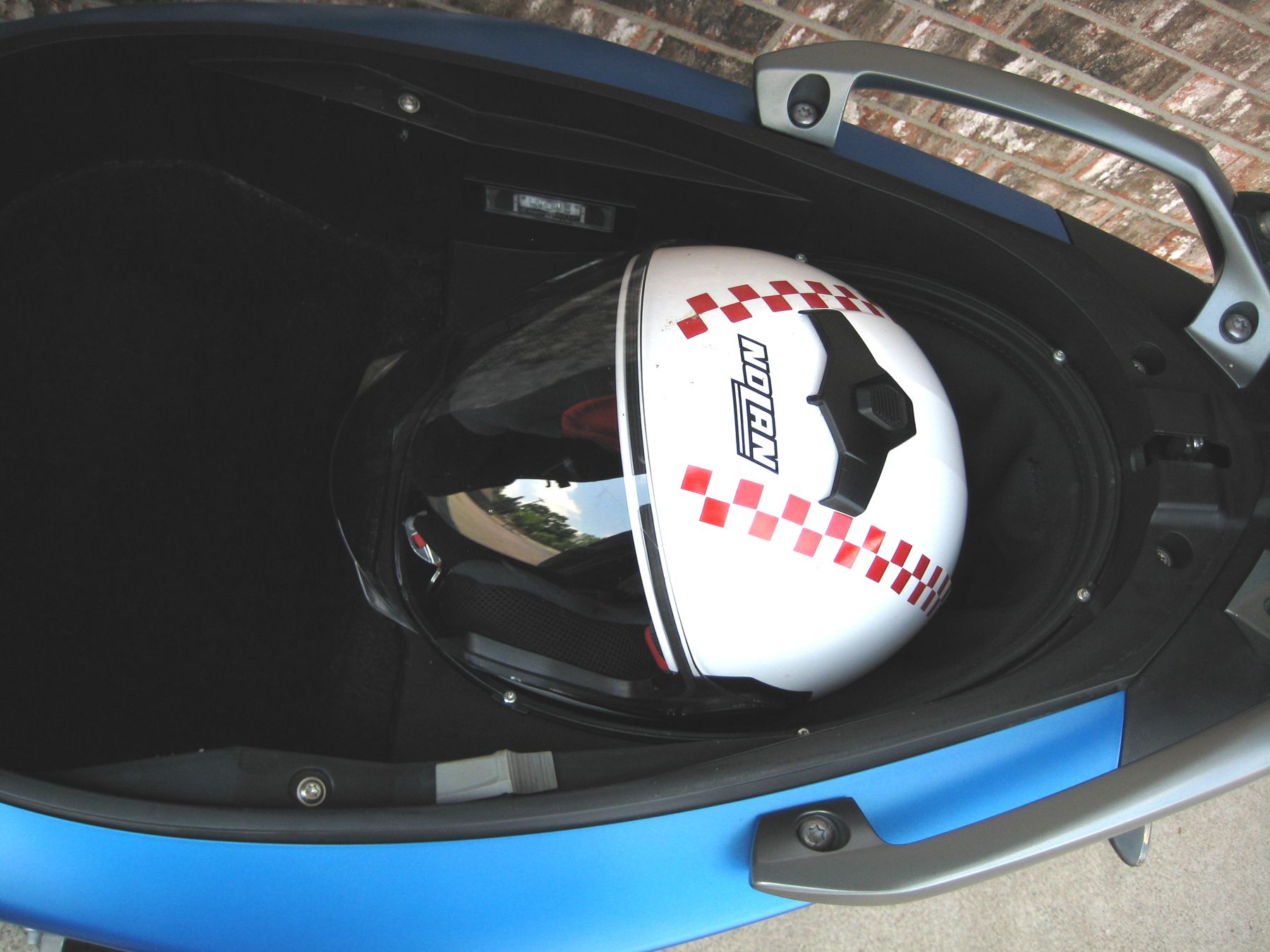 Close up of helmet inside BMW flexcase underneath the seat