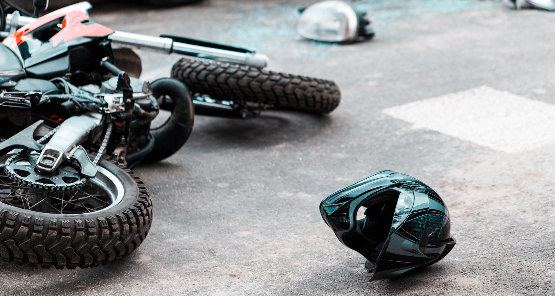 motocross motorcycle and a helmet lies on the road after an accident