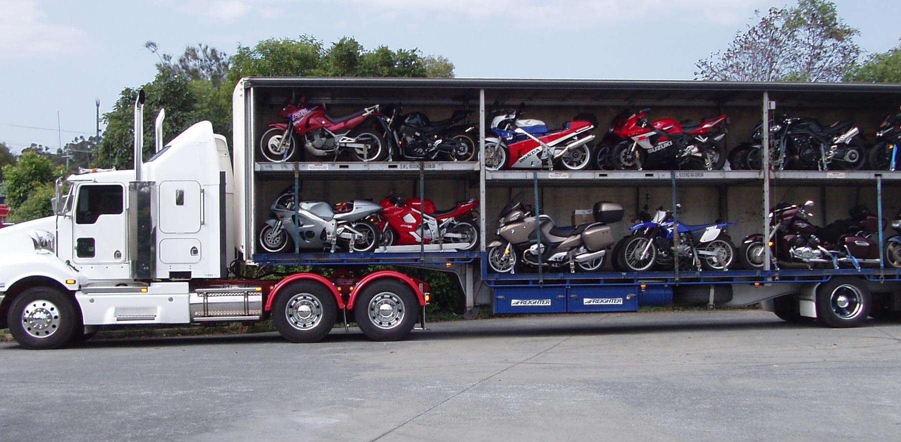 Many motorcycles in a transport trailer