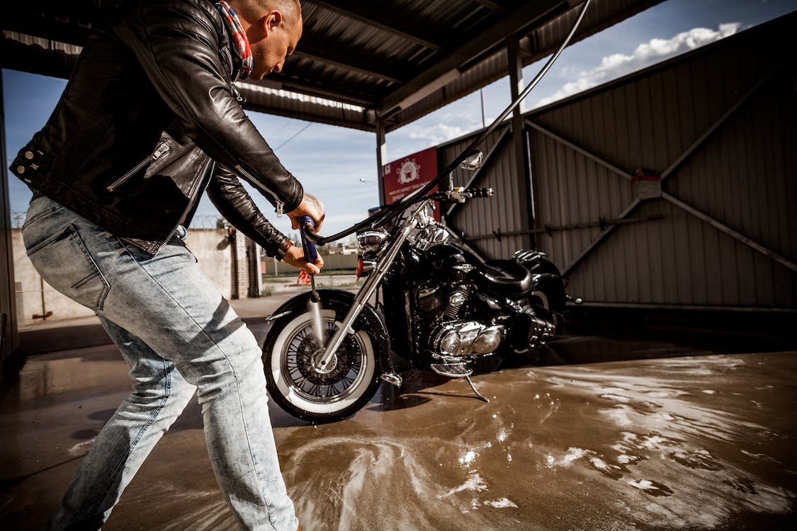 man washing motorcycle