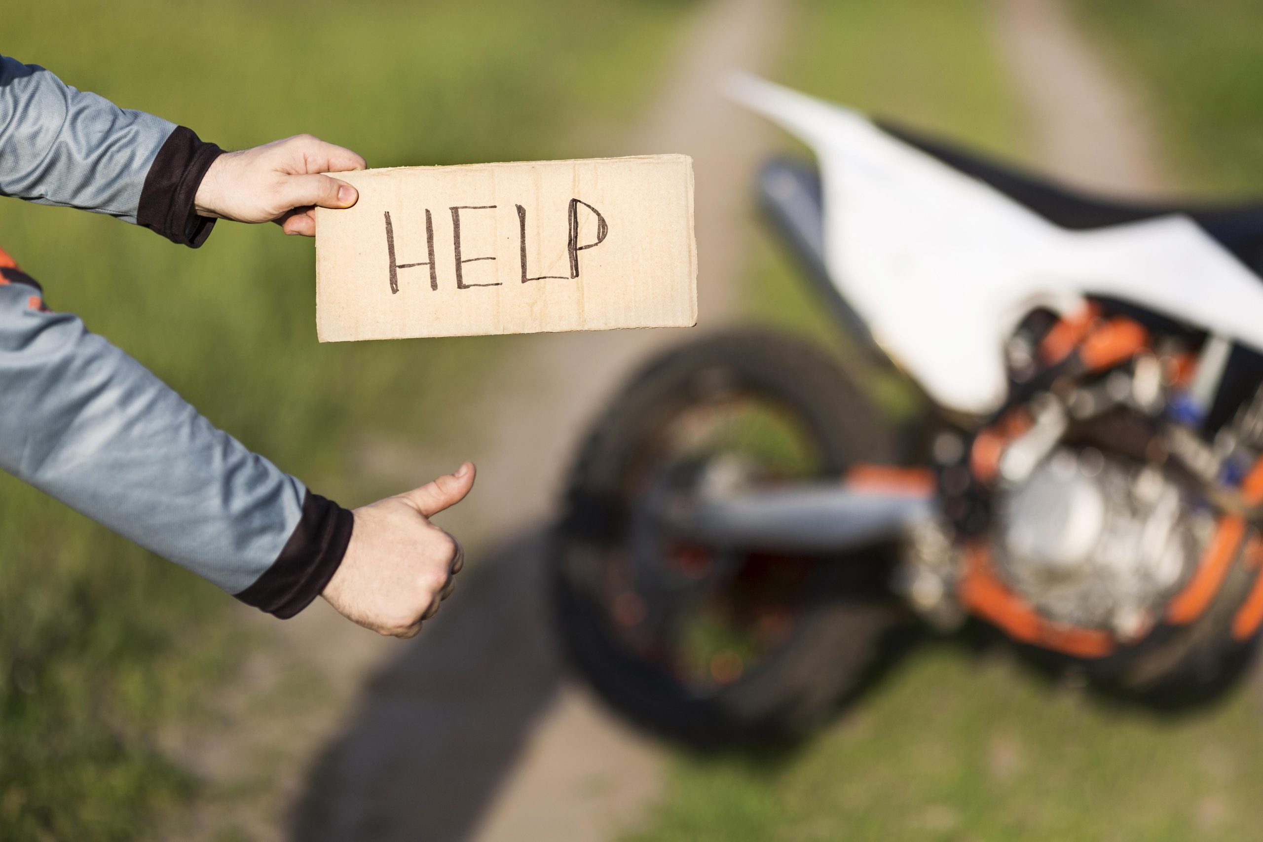 Close-up motorcycle rider looking for help in the forest