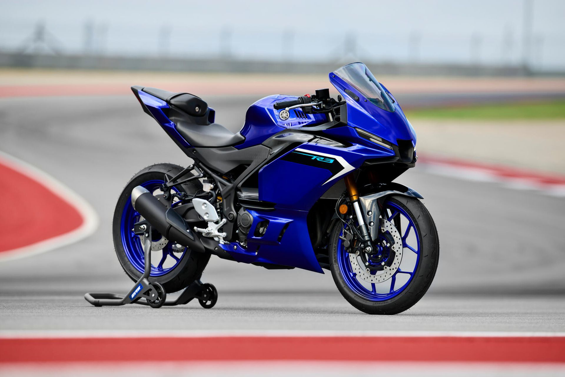 Three-quarter front view of a 2025 blue Yamaha R3 motorcycle